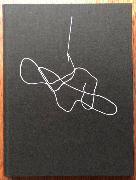 The photography book cover of Experimental Lake by Guillaume Simoneau. Hardback black with white line drawing.