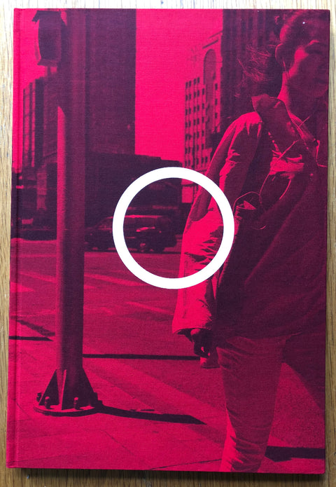 The photography book cover of Edit Beijing by Guy Tillim. Hardback in pink with a white circle in the middle.