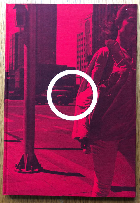 The photography book cover of Edit Beijing by Guy Tillim. Hardback in pink with a white circle in the middle.