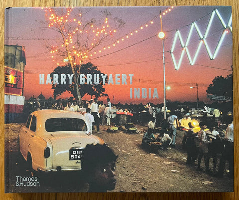 The photography book cover of India by Harry Gruyaert. Hardback in dark red with image of a red sky over india.