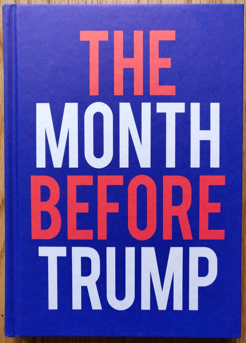 The photography book cover of The Month before Trump by Harvey Benge. Hardback in blue with a red and white large title.