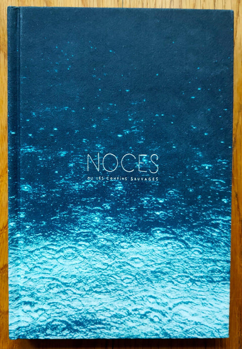 The photography book cover of Noces ou les Confins Sauvages by Helene David. Hardback with blue gradient cover image. signed.
