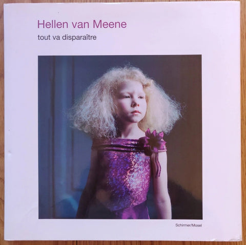 The photography book cover of Tout Va Disparaitre by Hellen van Meene. Hardback in pink with a little girl on the cover.