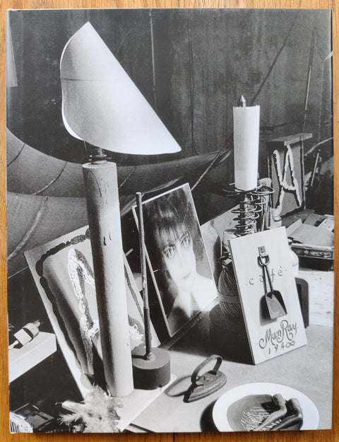 The photography book cover of The Studio of Man Ray by Ira Nowinski. Hardback in cream with B&W cover image of random objects.