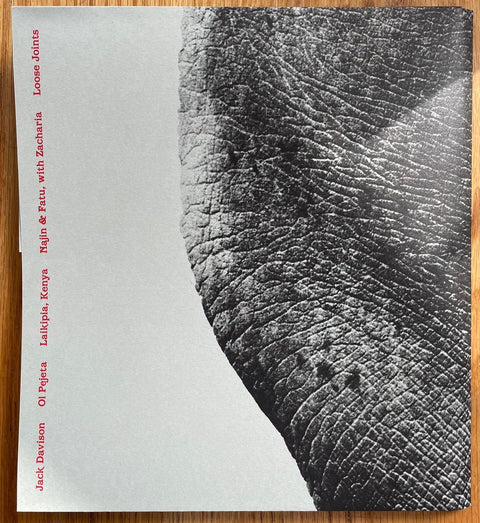 The photography book cover of Ol Pejeta by Jack Davison. Paperback in b&w with red sideways text.