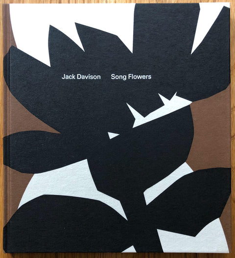 The photography book cover of Song Flowers by Jack Davison. Hardback with graphic design of black, white and brown flower shapes.