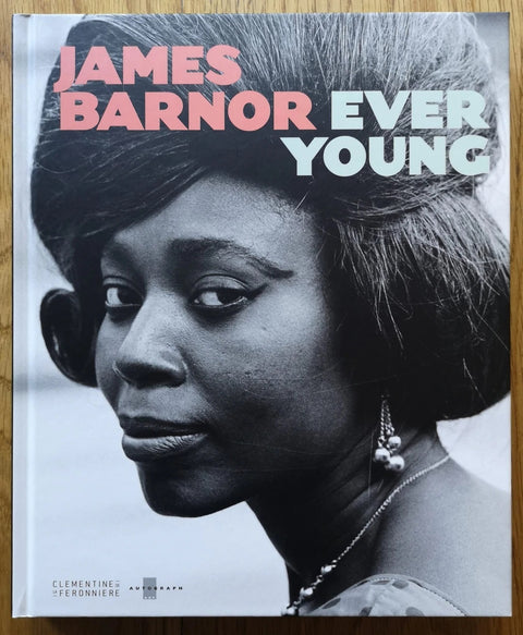 The photography book cover of Ever Young by James Barnor. Hardback with B&W cover image of a woman looking into the camera.
