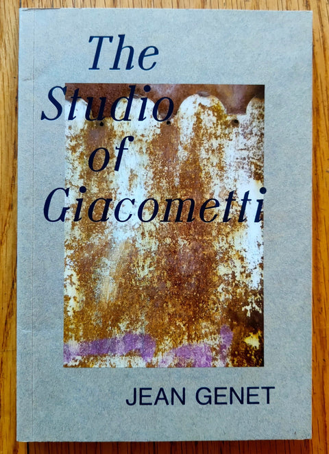 The photography book cover of The Studio of Giacometti by Jean Genet. Paperback in grey.