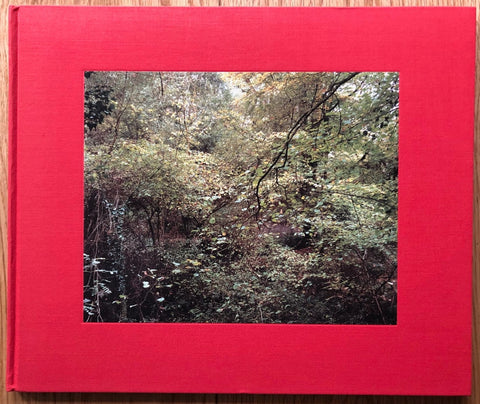 The photography book cover of The Painters Pool by Jem Southam. Hardback with a red border around image of shrubbery.