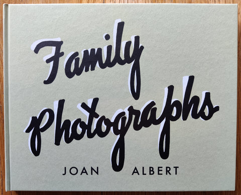The photobook cover of Family Photographs by Joan Albert. In hardcover light green.