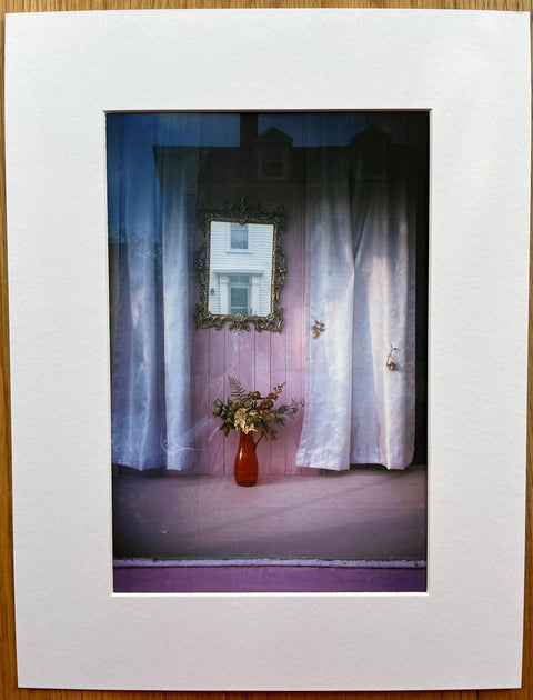 The print from photography book Wild Flowers by Joel Meyerowitz. Hardback book wtih print of flowers in a red vase beneath a mirror. Signed.