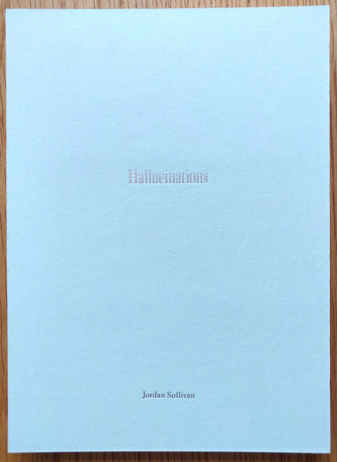 The photography book cover of Hallucinations by Jordan Sullivan. Paperback in white.