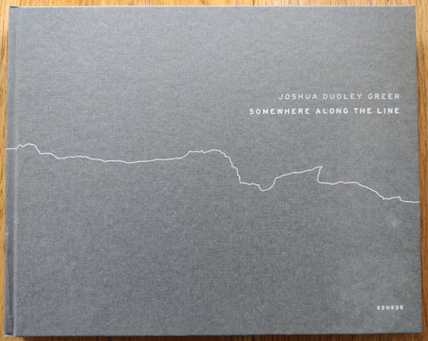 The photobook cover of Somewhere Along The Line by Joshua Dudley Greer. In hardcover grey with a white line.