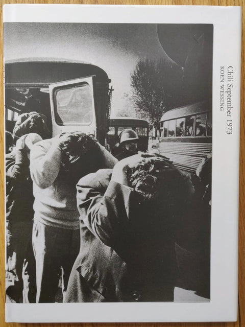 The photography book cover of Chili September 1973 by Koen Wessing. Hardback with B&W image of people with their hands on their heads.
