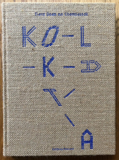 The photobook cover of Kolkata by Tiane Doan na Champassak. Hardback with fabric/textured cover and blue title. Signed.