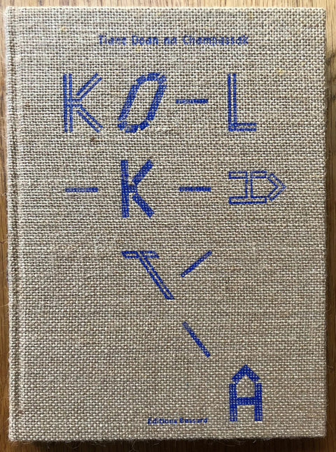 The photobook cover of Kolkata by Tiane Doan na Champassak. Hardback with fabric/textured cover and blue title. Signed.