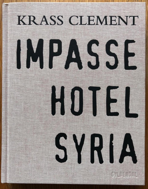 The photography book cover of Impasse Hotel Syria. Hardback in grey/beige.