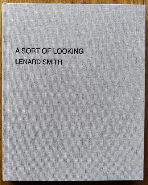 The photography book cover of A Sort of Looking by Lenard Smith. In hardcover beige.