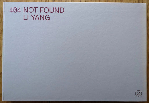 The photography book cover of 404 Not Found by Li Yang. Hardback in grey with title and author in top left corner.