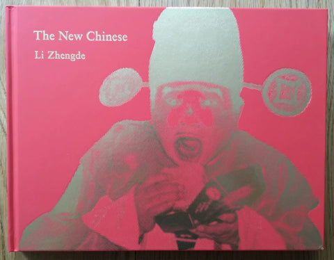 The photobook cover of The New Chinese by Li Zhengde. Hardback in pink and silver.