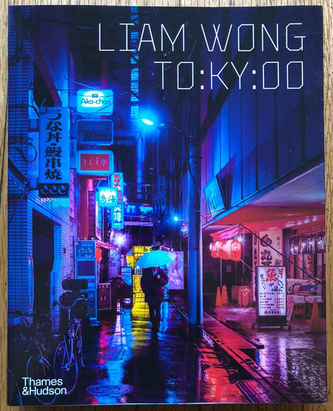 The photography book cover of TO:KY:OO by Liam Wong. Paperback with image of an alley in tokyo at night. Signed.