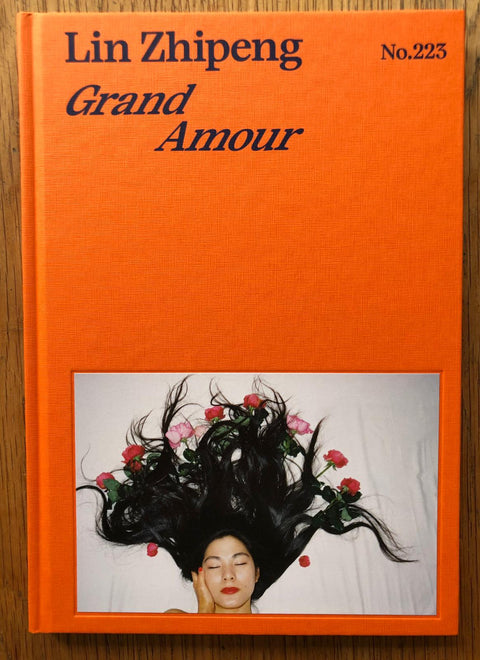 The photography book cover of Grand Amour by Lin Zhipeng. Hardback in bright orange.