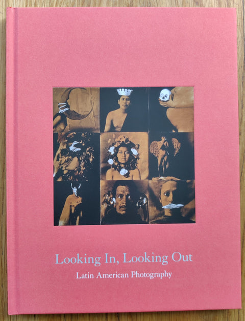 The photography book cover of Looking In, Looking Out: Latin American Photography by various artists. Hardback in pink.