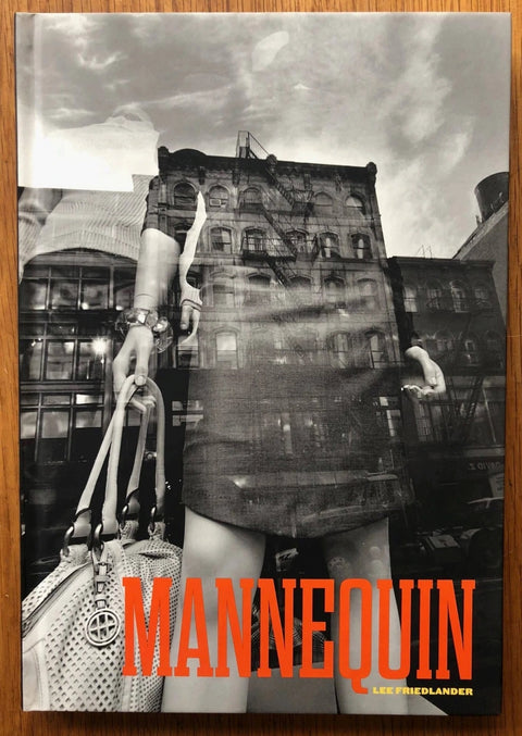 The photography book cover of Mannequin by Lee Friedlander. Hardback B&W cover with red title.