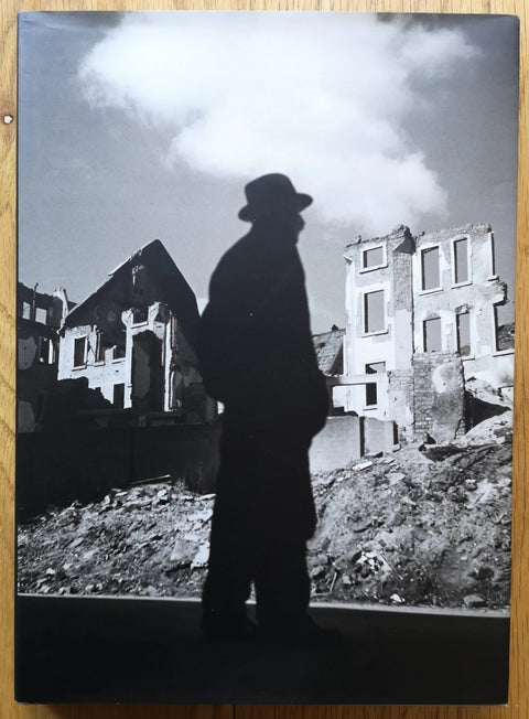 The photography book cover of Questions to my Father by Marco Bischof and Werner Bischof. Hardback in B&W with silhouette of a man with a top hat on.