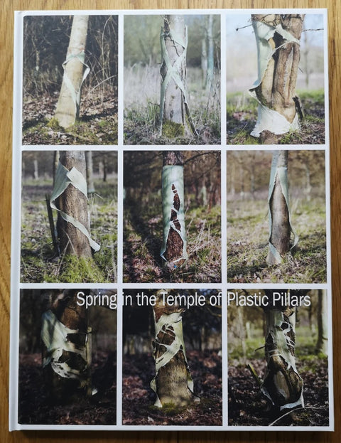 The photography book cover of Spring in the temple of plastic pillars by Mark Mattock. Hardback with 9 images of bound trees. Signed.