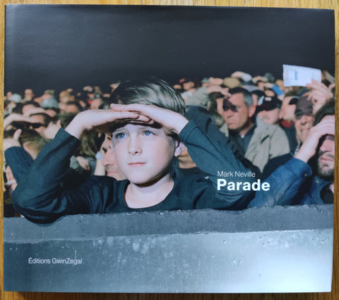 The photography book cover of Parade by Mark Neville. In dust jacketed hardcover grey.