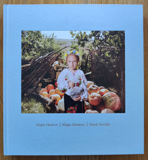 The photobook cover of Stop Tanks With Books by Mark Neville. Second edition. In hardcover baby blue.