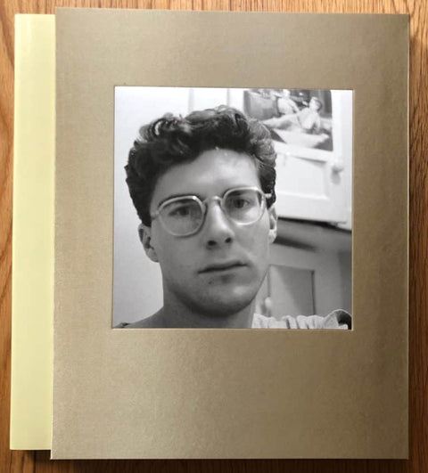 The photography book cover of Angel City West 2 by Mark Steinmetz. Hardback in brown/grey with a B&W cover image of man in glasses.