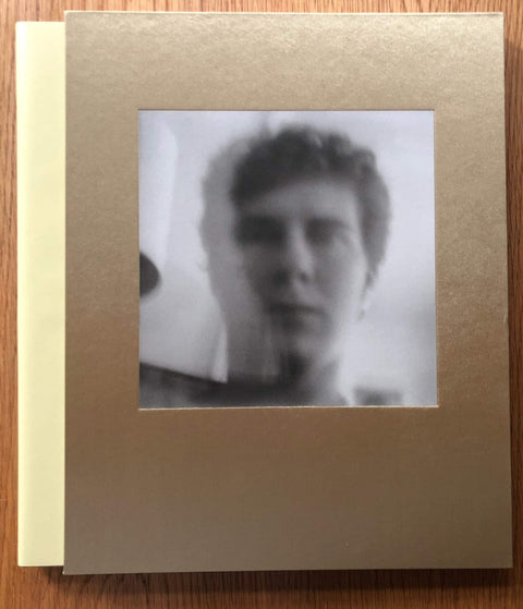 The photography book cover of Angel City West 3 by Mark Steinmetz. Hardback in gold/brown with B&W cover image of a man.
