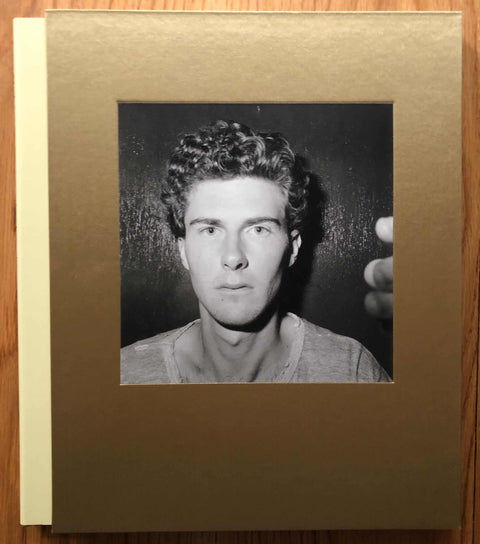 The photography book cover of Angel City West by Mark Steinmetz. Hardback in brown/gold with B&W image of a man on the cover.