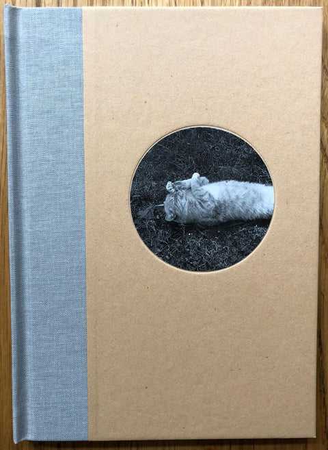 The photography book cover of Cats by Mark Steinmetz. Hardback with picture of a cat in a small circle in the middle. Signed.