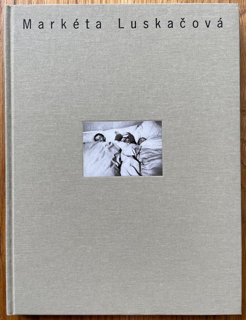 The photography book cover of the monograph for Marketa Luskacova. Hardback in beige/grey with small centred photo.