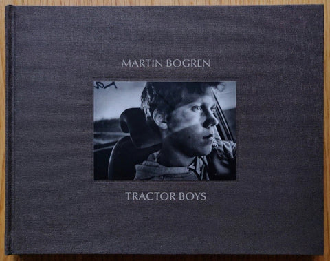 The photography book cover of Tractor Boys by Martin Bogren. Hardback in grey with image of a boy in the middle.
