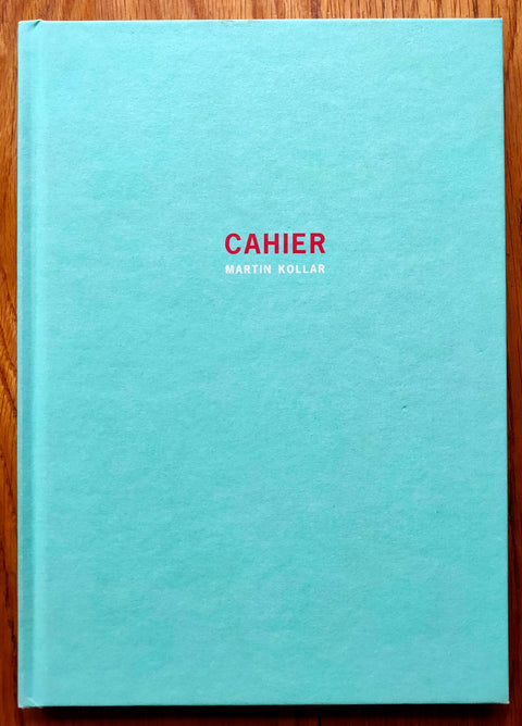 The photography book cover of Cahier by Martin Kollar. Hardback in bright blue with red centred title. Signed.