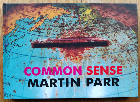 The photography book cover of Common Sense by Martin Parr. Hardback with image of a globe money bank. Signed.