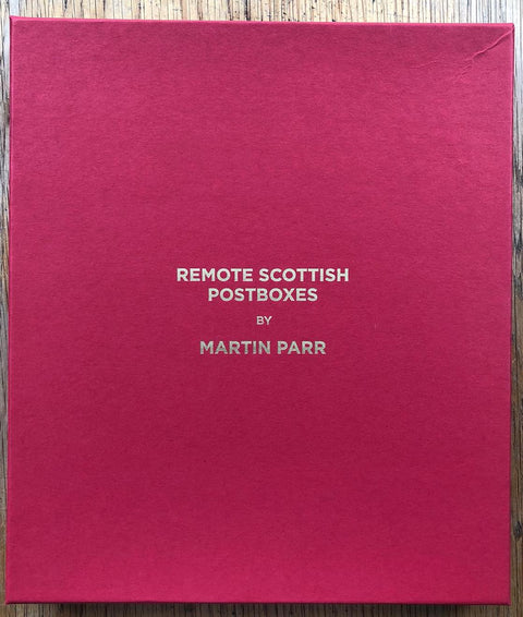 The photography book cover of Remote Scottish Postboxes by Martin Parr. Hardback in red.