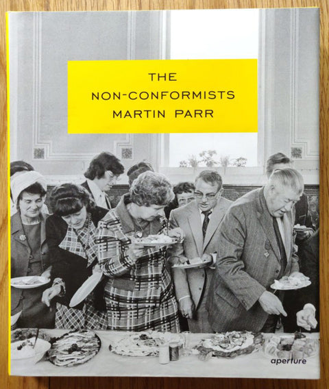 The photography book cover of The Non Conformists by Martin Parr. Hardback in B&W with title in a yellow box.