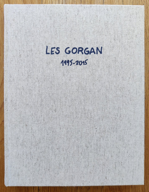The photography book cover of Les Gorgan 1995 - 2015 by Mathieu Pernot. In hardcover beige.