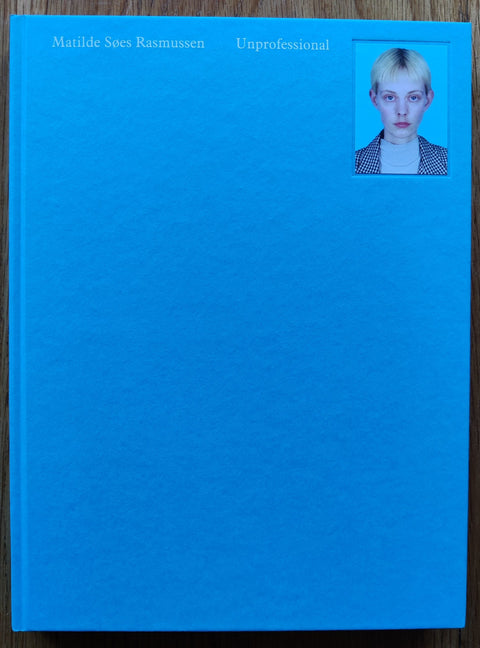 The photography book cover of Unprofessional by Matilde Søes Rasmussen. In hardcover blue.