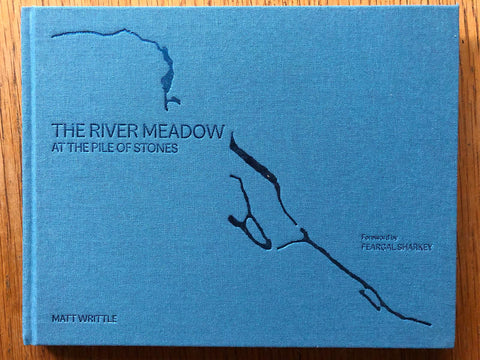 The photography book cover of The River Meadow at the Pile of Stones by Matt Writtle. Hardback in blue. Signed.