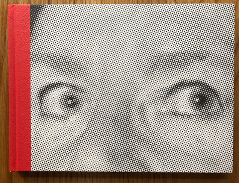 The photography book cover of Event by Matthew Beck. Hardback with dotted image of someones eyes. Red binding.