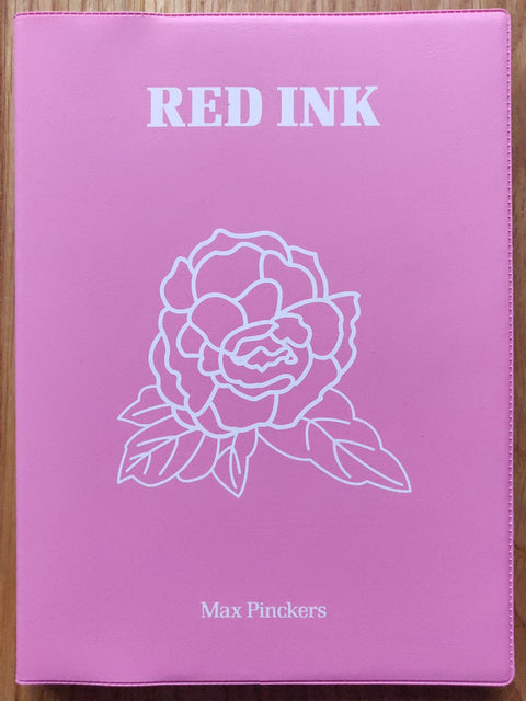 The photography book cover of Red Ink by Max Pinckers. Paperback in pink with a white line drawing of a rose on the cover.