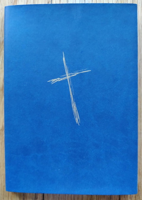 The photography book cover of Every Cross on Cross Montain by Michael Alberry. In dust jacketed softcover blue.