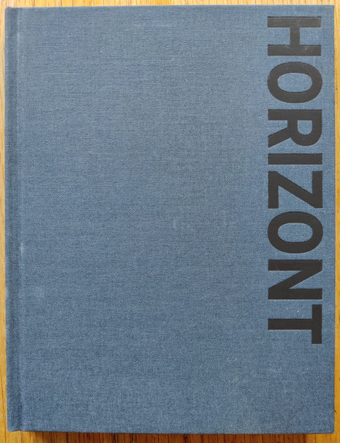 The photography book cover of Horizont by Michael Ashkin. In hardcover blue.