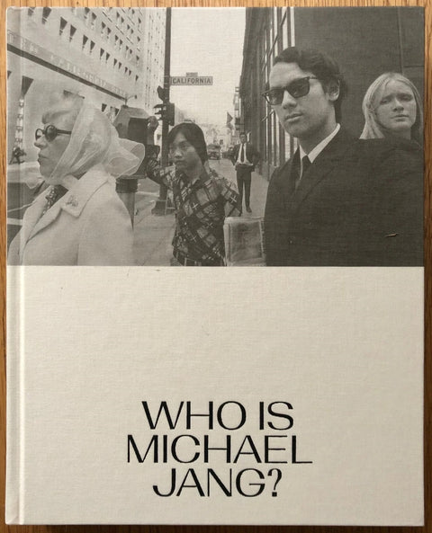 The photography book cover of Who is Michael Jang? by Michael Jang. Hardback in cream in B&W / sepia on the top half.
